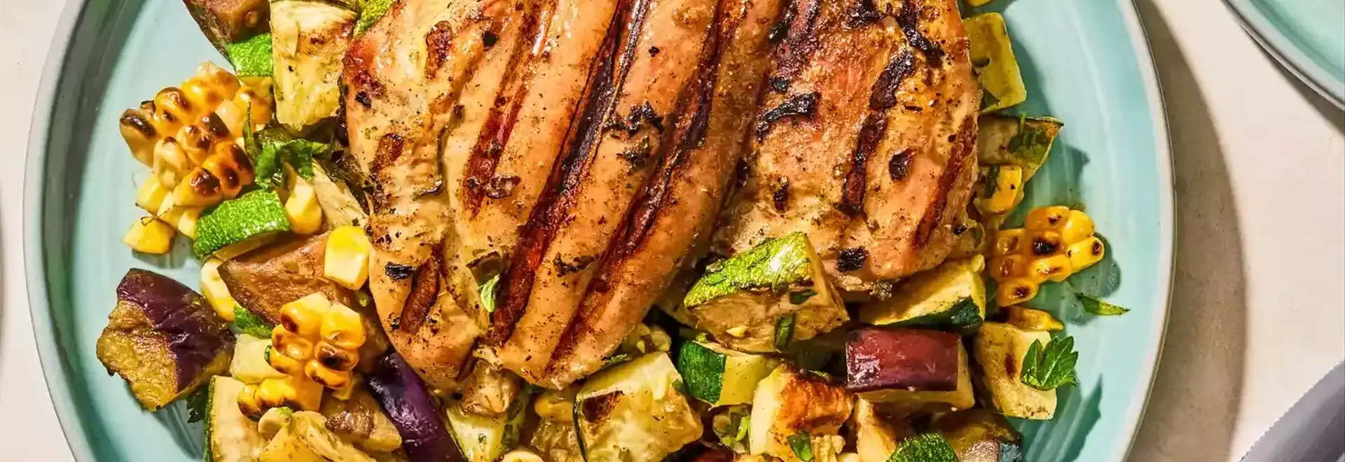Flavorful Herb-Marinated Chicken Thighs with Grilled Vegetable Medley